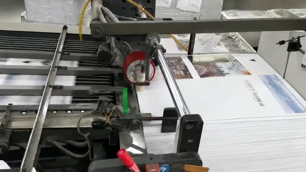 Days of You and Me book pages running through a printing press