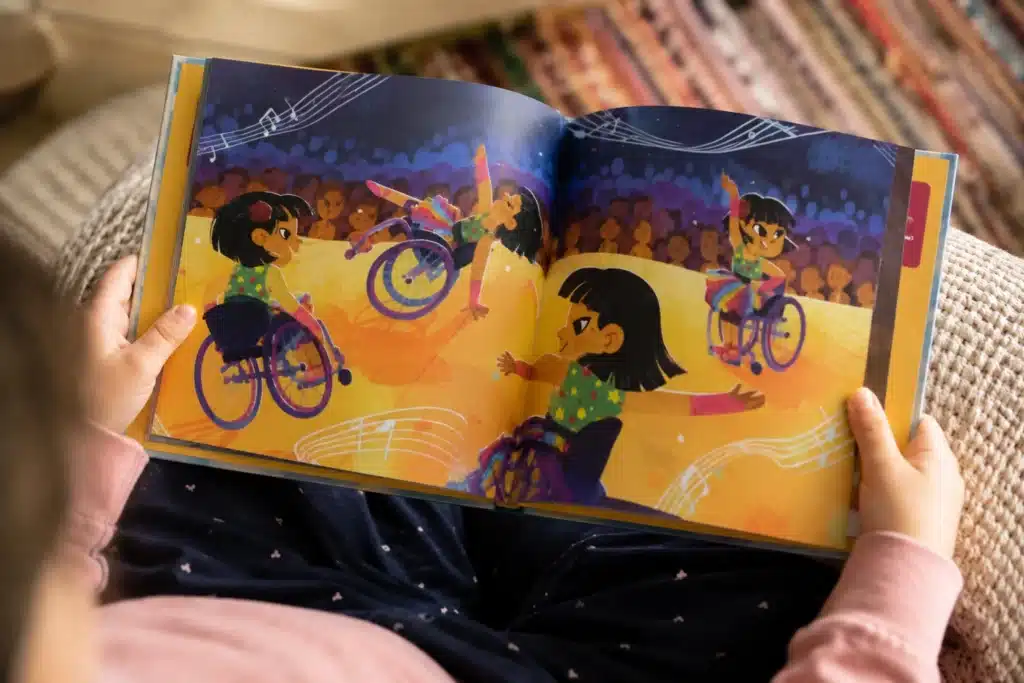 Child holding an open Mighty Mara picture book